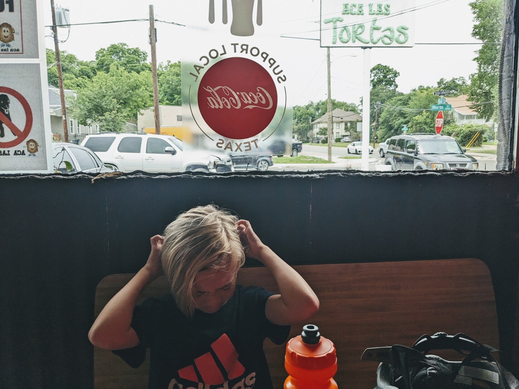 A photo of Milo, 9, sitting in a restaurant