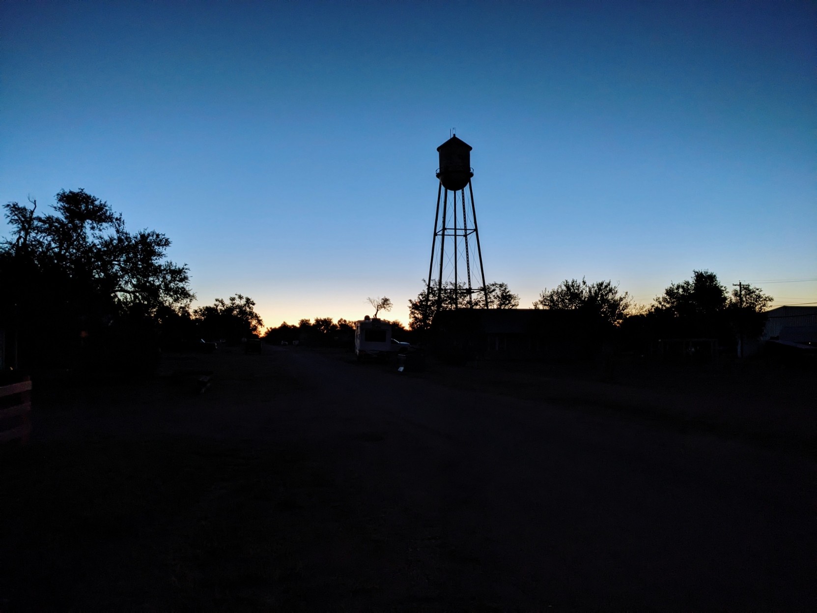 Sunrise behind a water tower