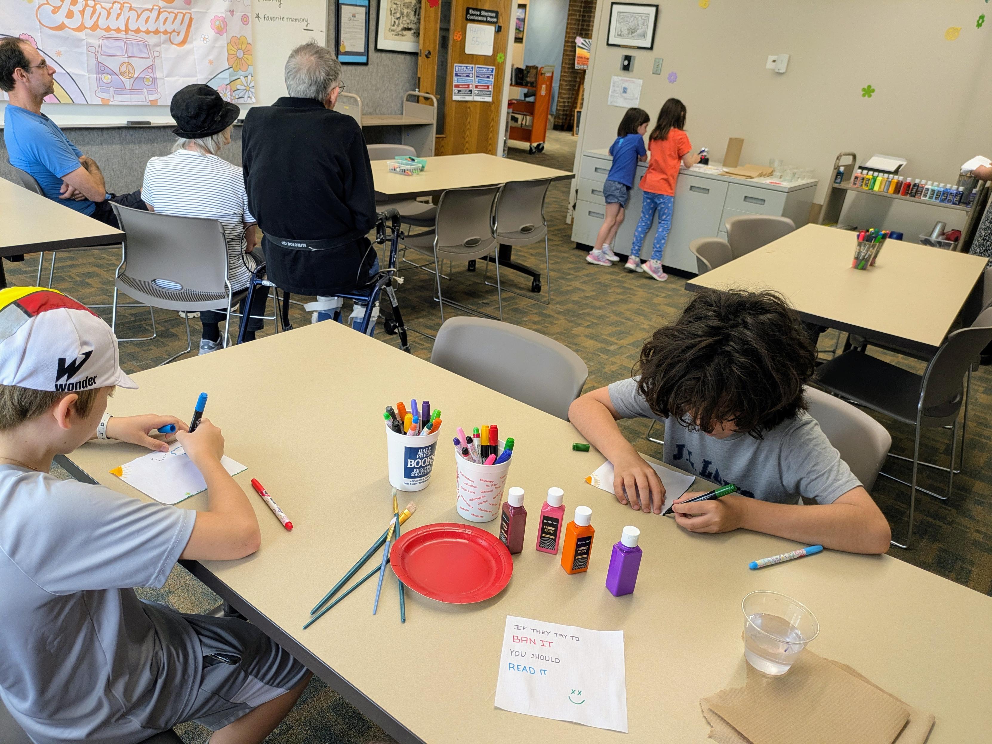 Two boys painting quilt squares